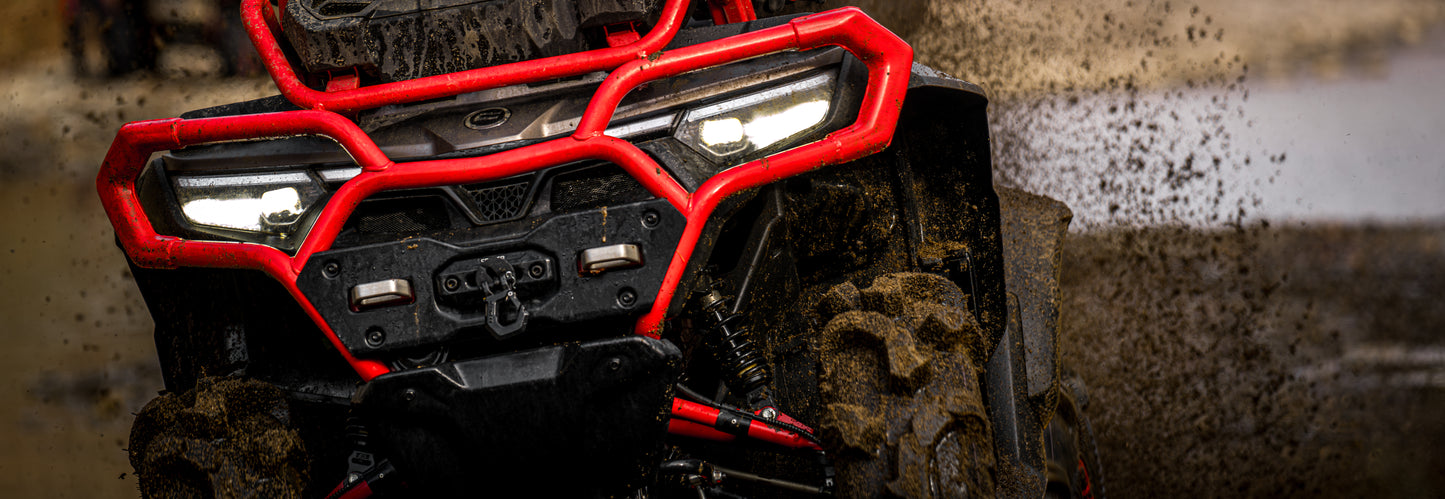 Close-up of a CFMOTO 1000 MV off-road vehicle with mud on tires