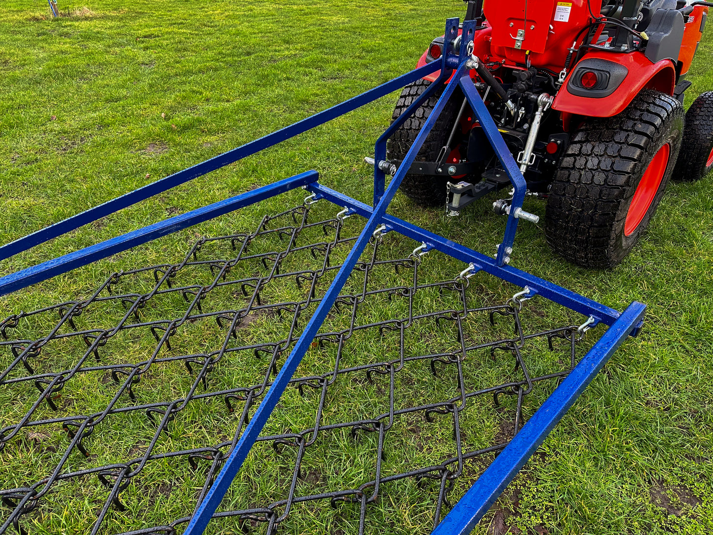 FarmMaster Framed Chain Harrow attached to a Kioti tractor on grass