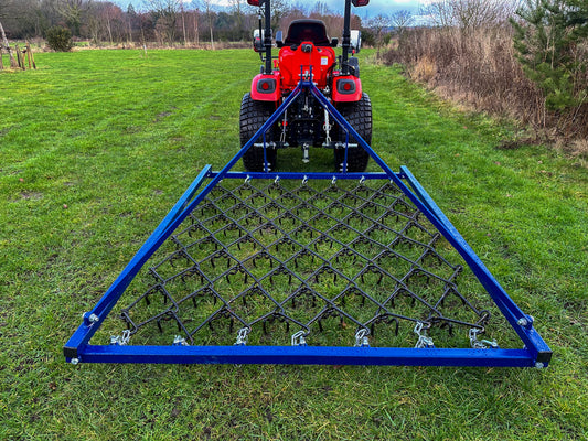 FarmMaster Framed Chain Harrow attached to a Kioti tractor on a grassy field