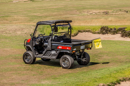 Kioti K9 Utility vehicle on a golf course with a sand trap in the background