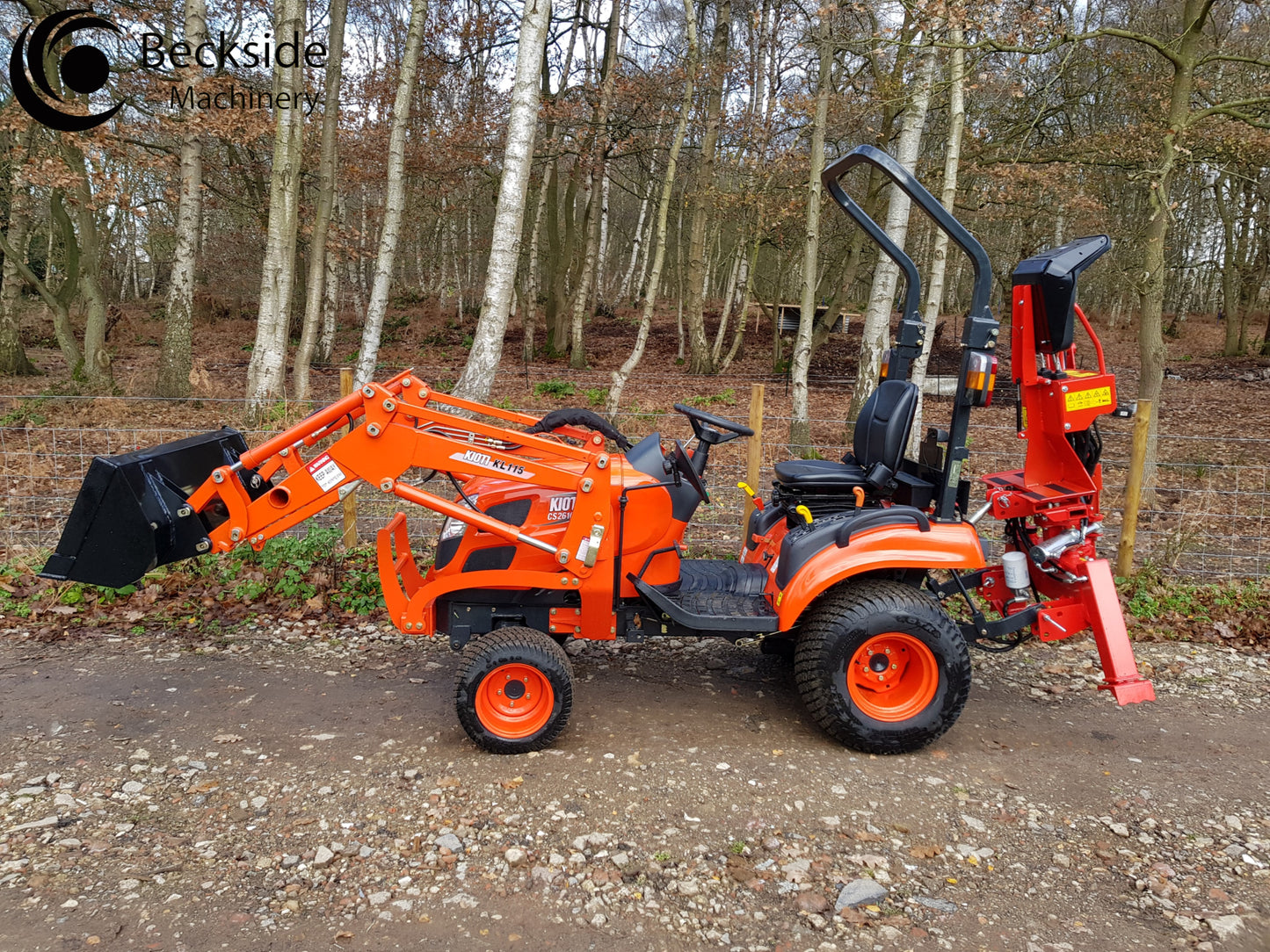 Kioti tractor with FarmMaster tractor backhoe in a forest setting