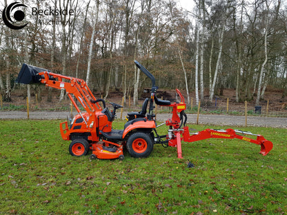 Orange tractor with FarmMaster LandLugger tractor backhoe on a grassy area with trees in the background