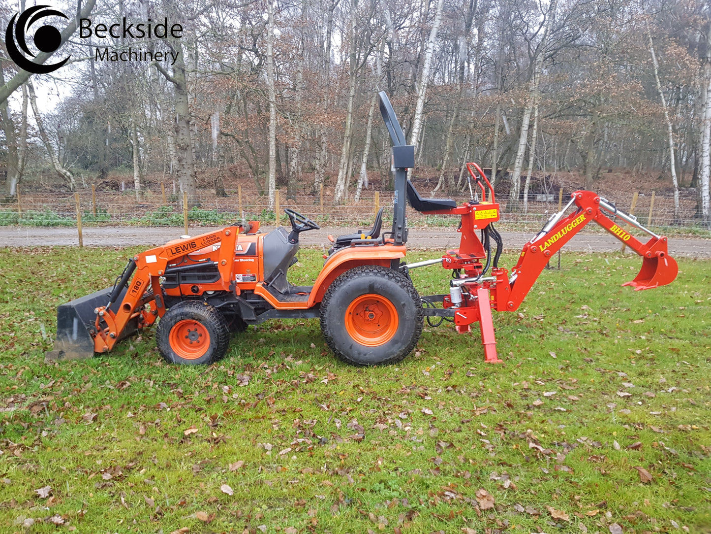 Small orange tractor with FarmMaster LandLugger tractor backhoe