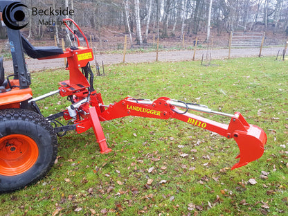 FarmMaster LandLugger tractor backhoe on a tractor in an outdoor setting with trees and grass.