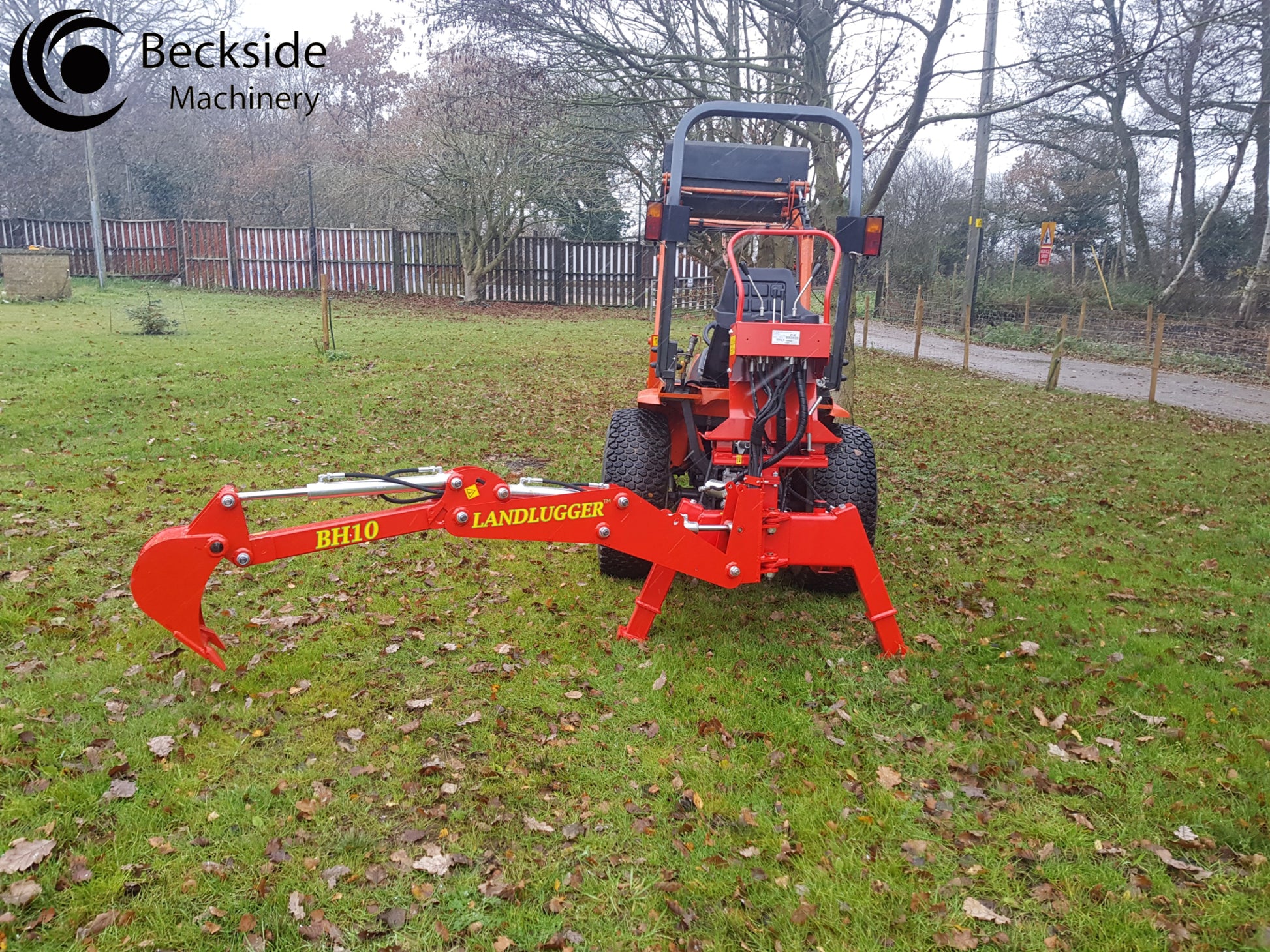 Red tractor with a FarmMaster LandLugger tractor backhoe