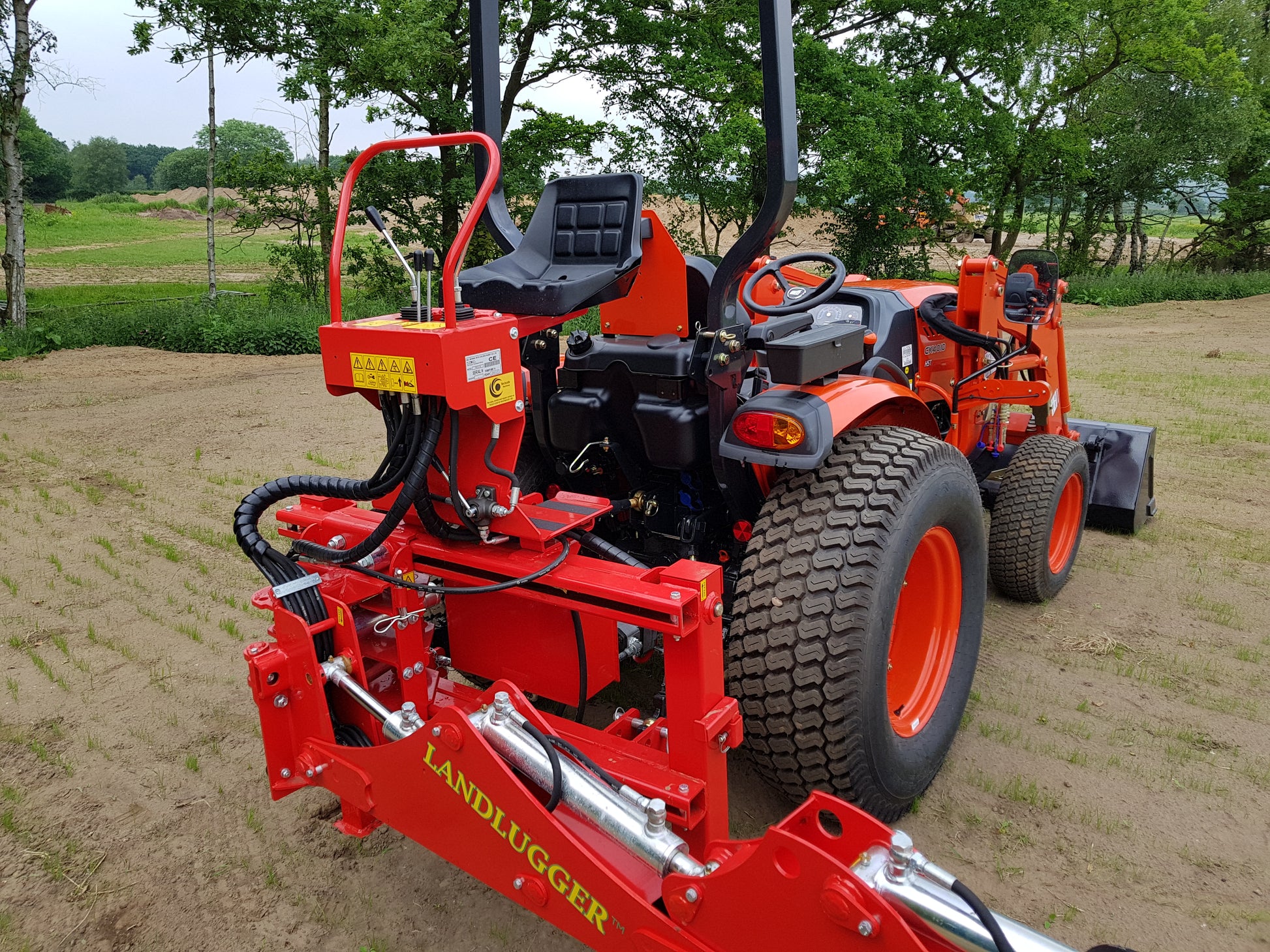 FarmMaster LandLugger tractor backhoe in a field