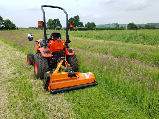 FarmMaster flail mower attachment cutting through grass in a field.