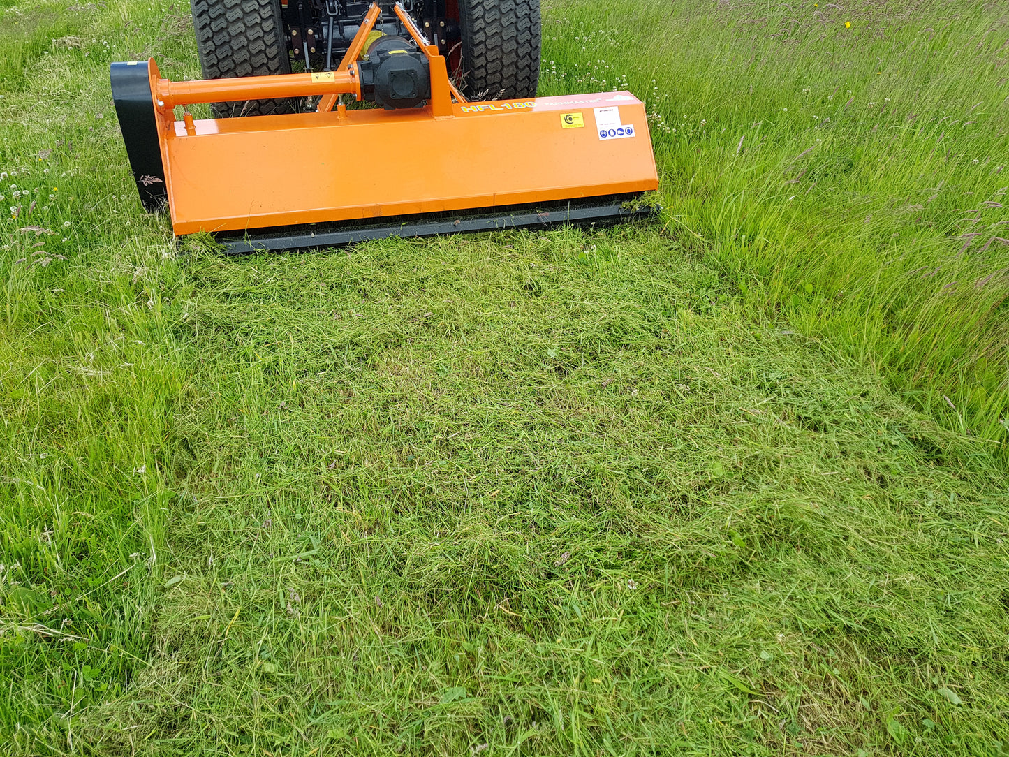 FarmMaster tractor flail mower being used on a grassy field