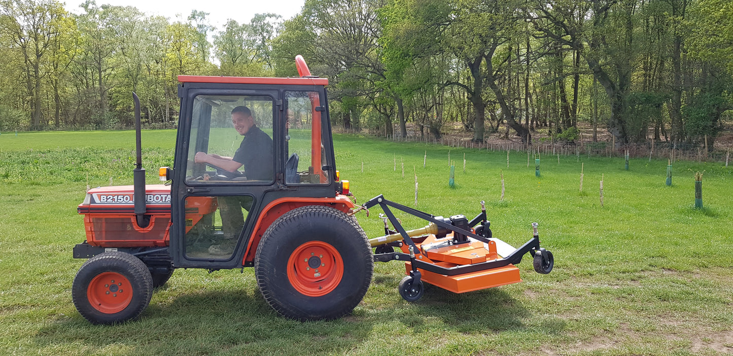 Tractor with a FarmMaster finishing mower attachment in a grassy field
