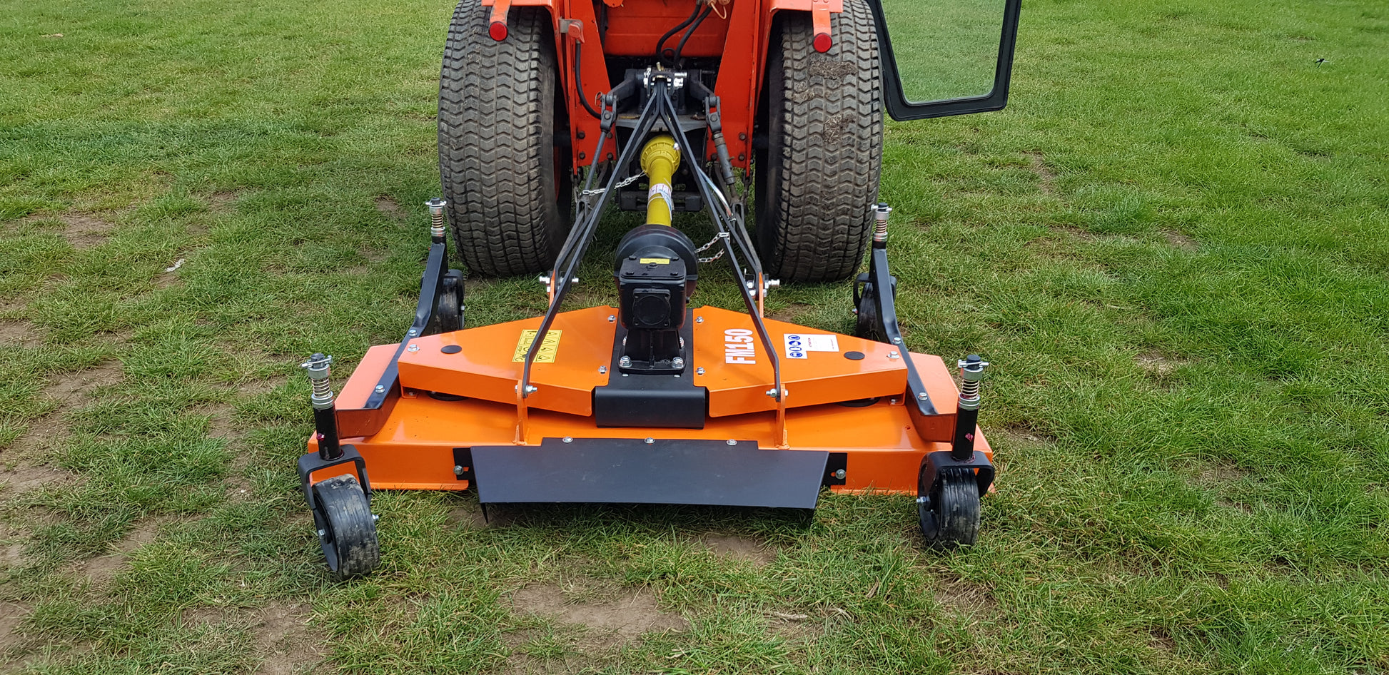 FarmMaster tractor finishing mower on a tractor in a grassy field