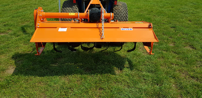 FarmMaster tractor rotavator attachment on a tractor in a grassy field