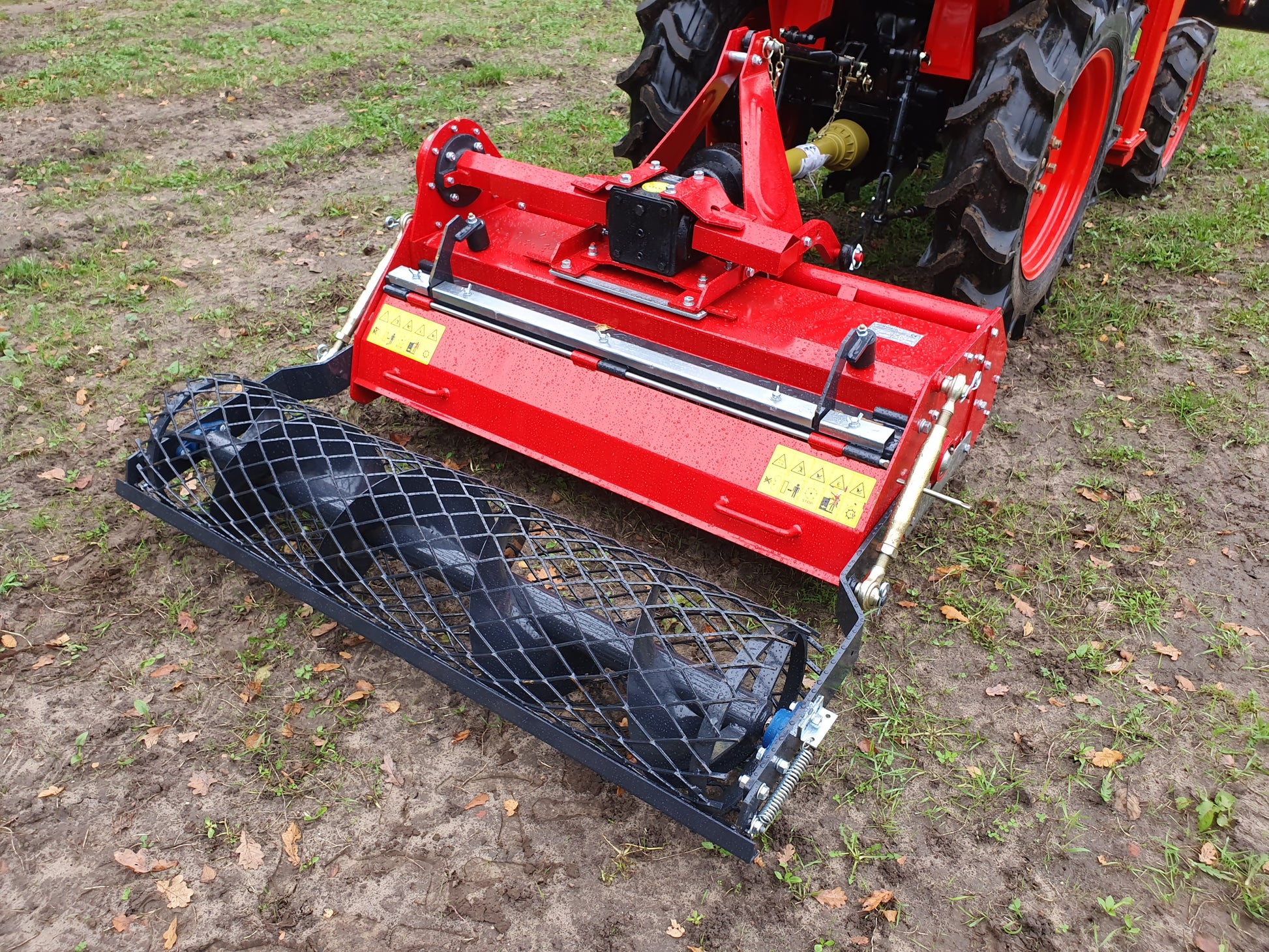FarmMaster Stone Burier attached to a tractor on a field