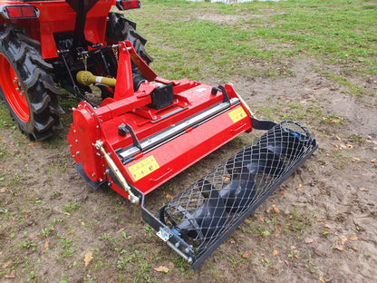 FarmMaster tractor stone burier attachment on a tractor in a field