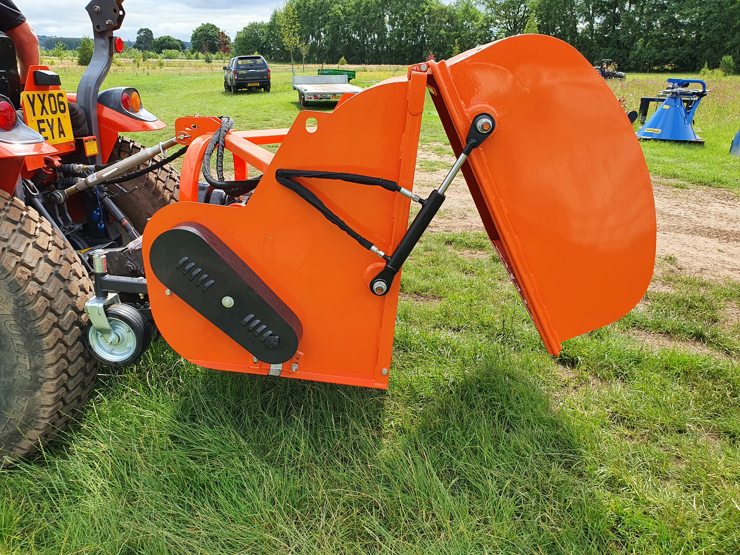 FarmMaster flail collector attachment on a tractor in a field