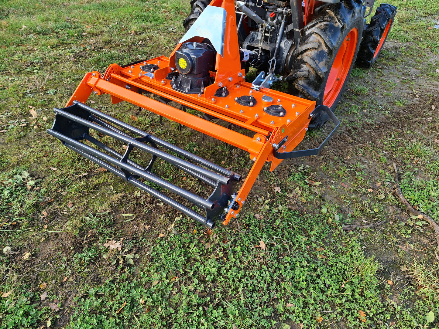 FarmMaster power harrow attachment on a tractor in a field