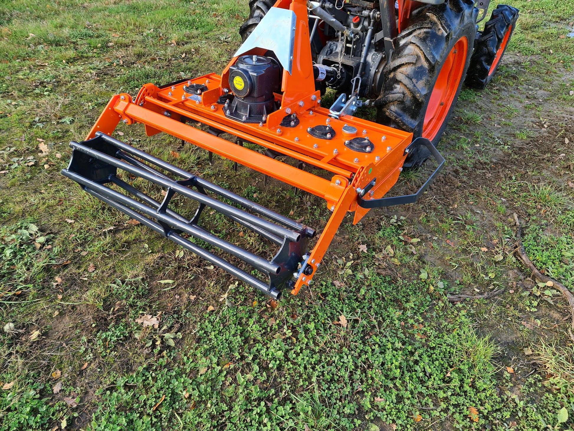 FarmMaster power harrow attachment on a tractor in a field
