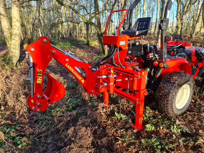FarmMaster LandLugger tractor backhoe in a forest setting