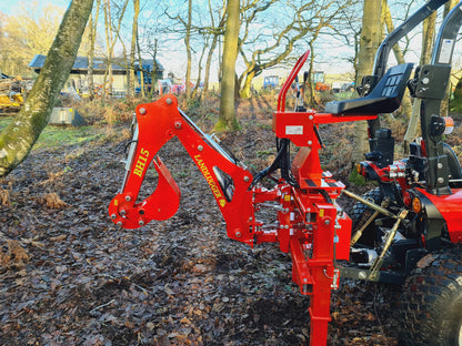 FarmMaster LandLugger tractor backhoe on a tractor in a wooded area
