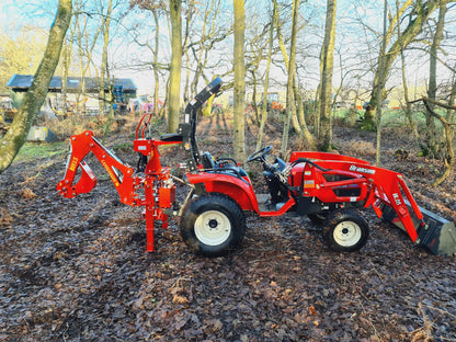 FarmMaster LandLugger tractor backhoe in a wooded area
