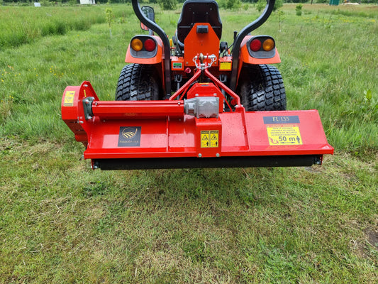 FarmMaster tractor flail mower attached to a tractor on a grassy field