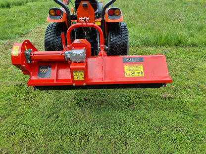 FarmMaster Pro offset flail mower  attached to a tractor on a grassy field