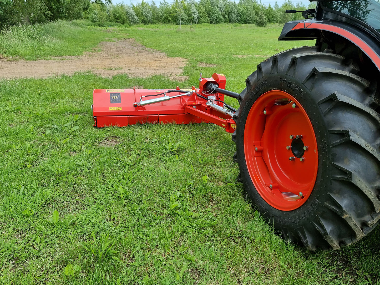 FarmMaster Pro Verge Flail Mower attached to a tractor on a grassy field