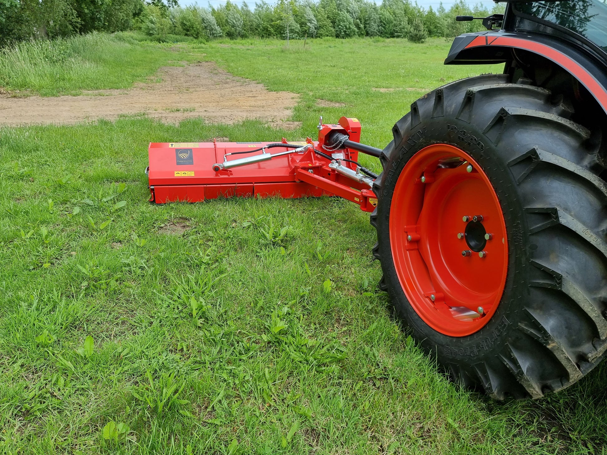 FarmMaster Pro Verge Flail Mower attached to a tractor on a grassy field