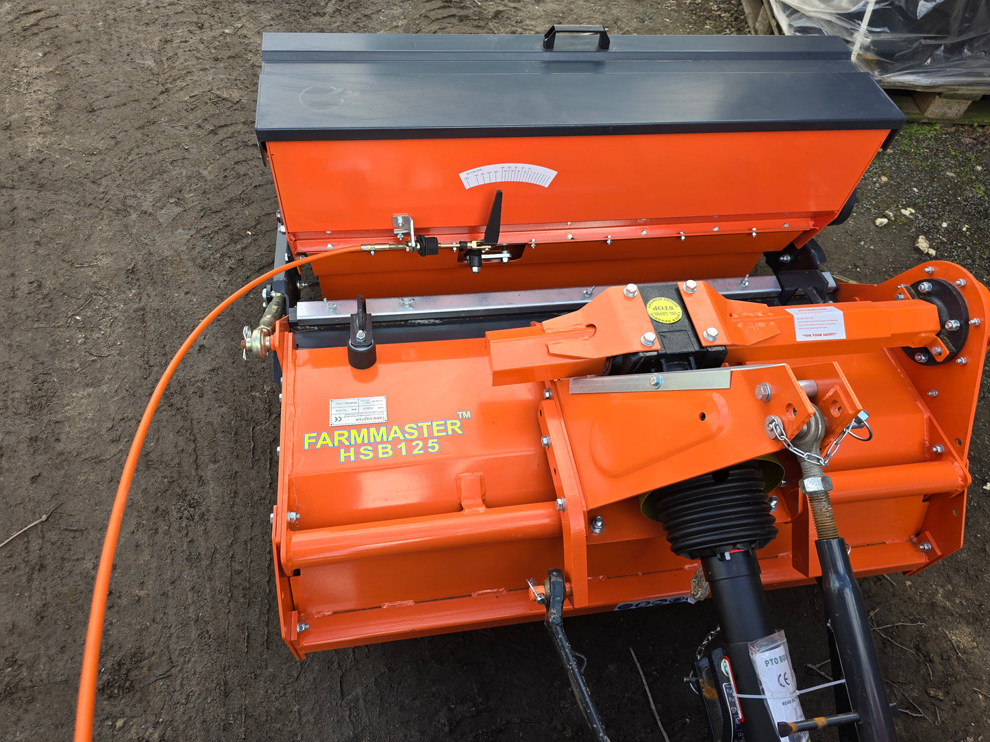 FarmMaster stone burier with seeder on a dirt surface