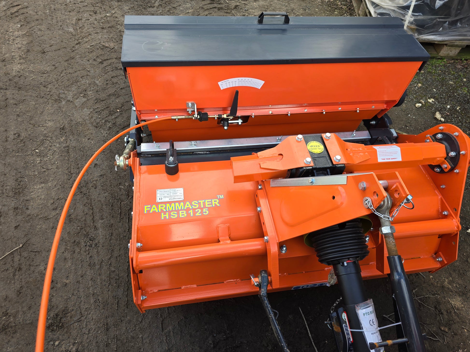 FarmMaster stone burier with seeder on a dirt surface