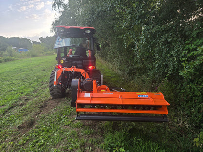 Tractor with a mounted FarmMaster Verge Flail Mower cutting through grass and bushes.