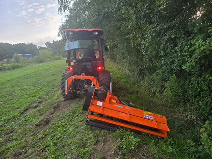 Tractor with a FarmMaster Verge Flail Mower attachment cutting through grass and brush in a field.