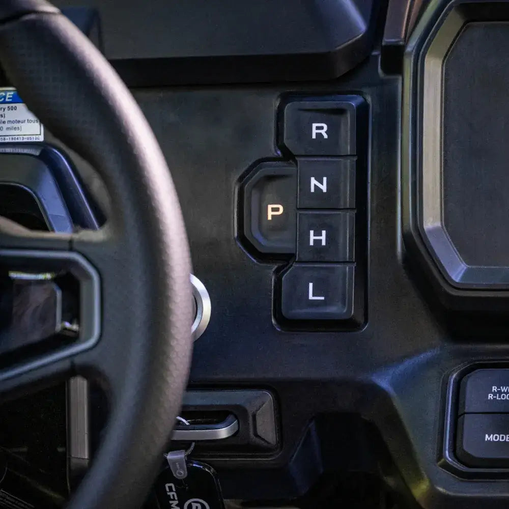 Close-up of a CFMOTO UTV's gear shift with 'P', 'R', 'N', 'L', and 'H' indicators.