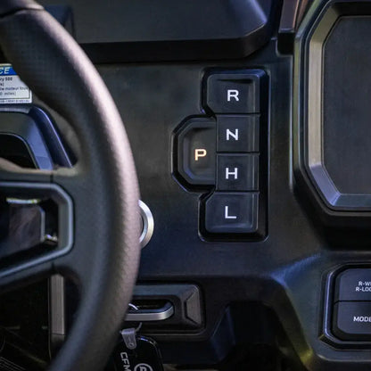 Close-up of a CFMOTO UTV's gear shift with 'P', 'R', 'N', 'L', and 'H' indicators.