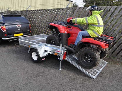 Person loading a Logic ATV Trailer