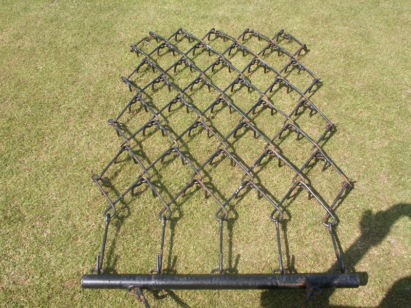Chain harrow on a grassy background