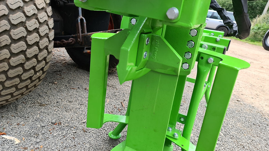 Close-up of a green FarmMaster Goliath tractor log splitter
