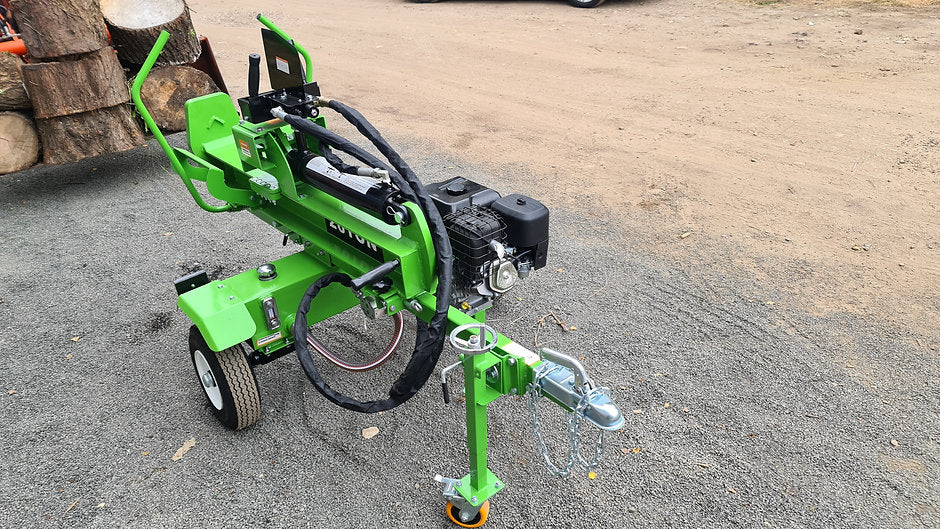 FarmMaster Goliath petrol log splitter on a gravel surface with logs in the background