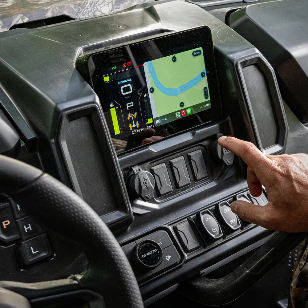 Person interacting with a touchscreen display in a CFMOTO UTV dashboard