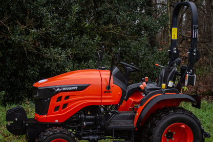 Orange and black tractor with 'Avenger' branding in a forest setting