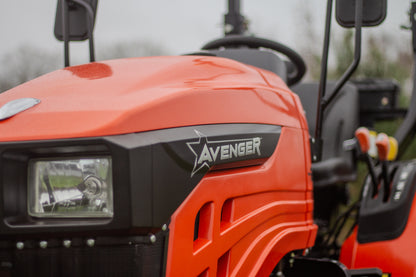 Close-up of an orange Avenger compact tractor with visible branding.