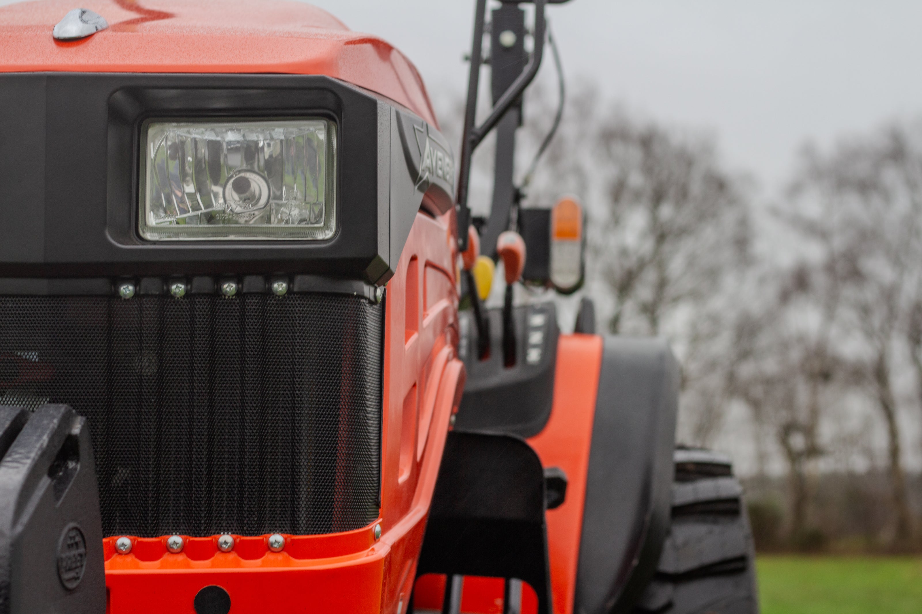 Close-up of an Orange Avenger tractor with a blurred background