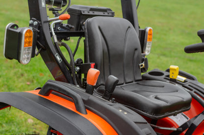 Close-up of a black seat on an Avenger 26 tractor with grass in the background