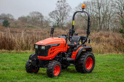 Avenger 26 tractor on a grassy field with trees in the background