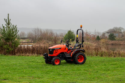 Avenger tractor on a grassy field with a cloudy sky