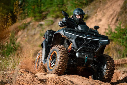 Person riding a CFMOTO  ATV on a dirt trail with a helmet