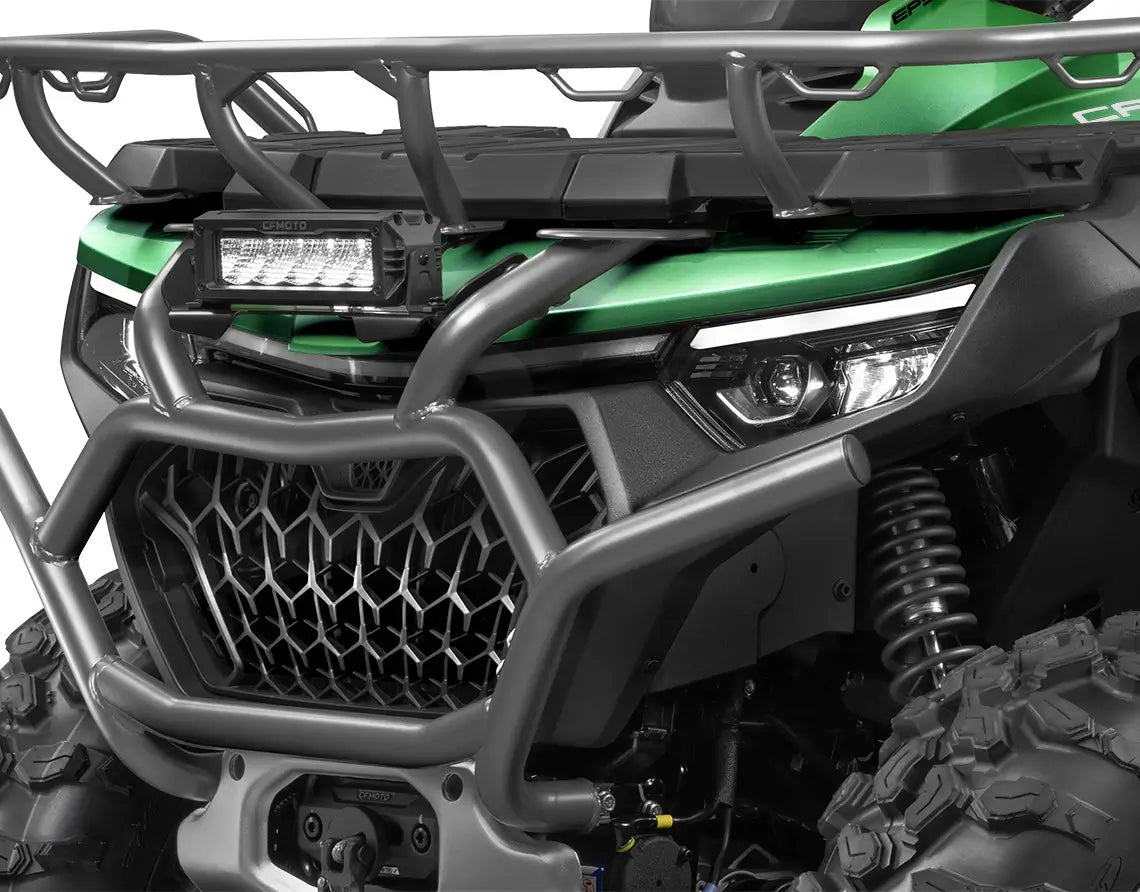 Close-up of a green CFMOTO ATV with front grille and headlights.