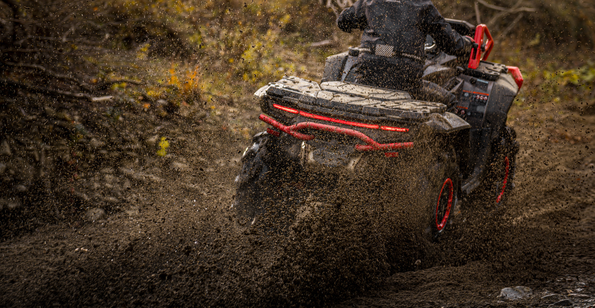 Person riding a CFMOTO 1000 MV ATV through a muddy landscape
