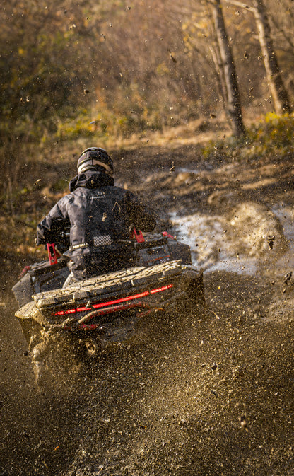 Person driving a CFMOTO 1000 MV  through a muddy field