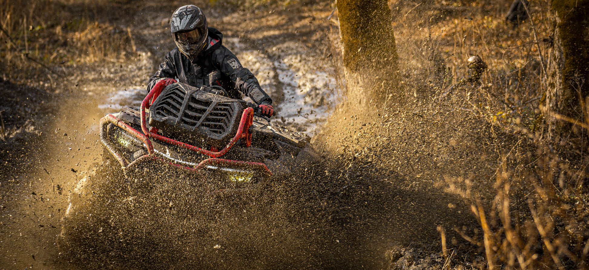 Person riding a CFMOTO 1000 MV ATV through muddy terrain
