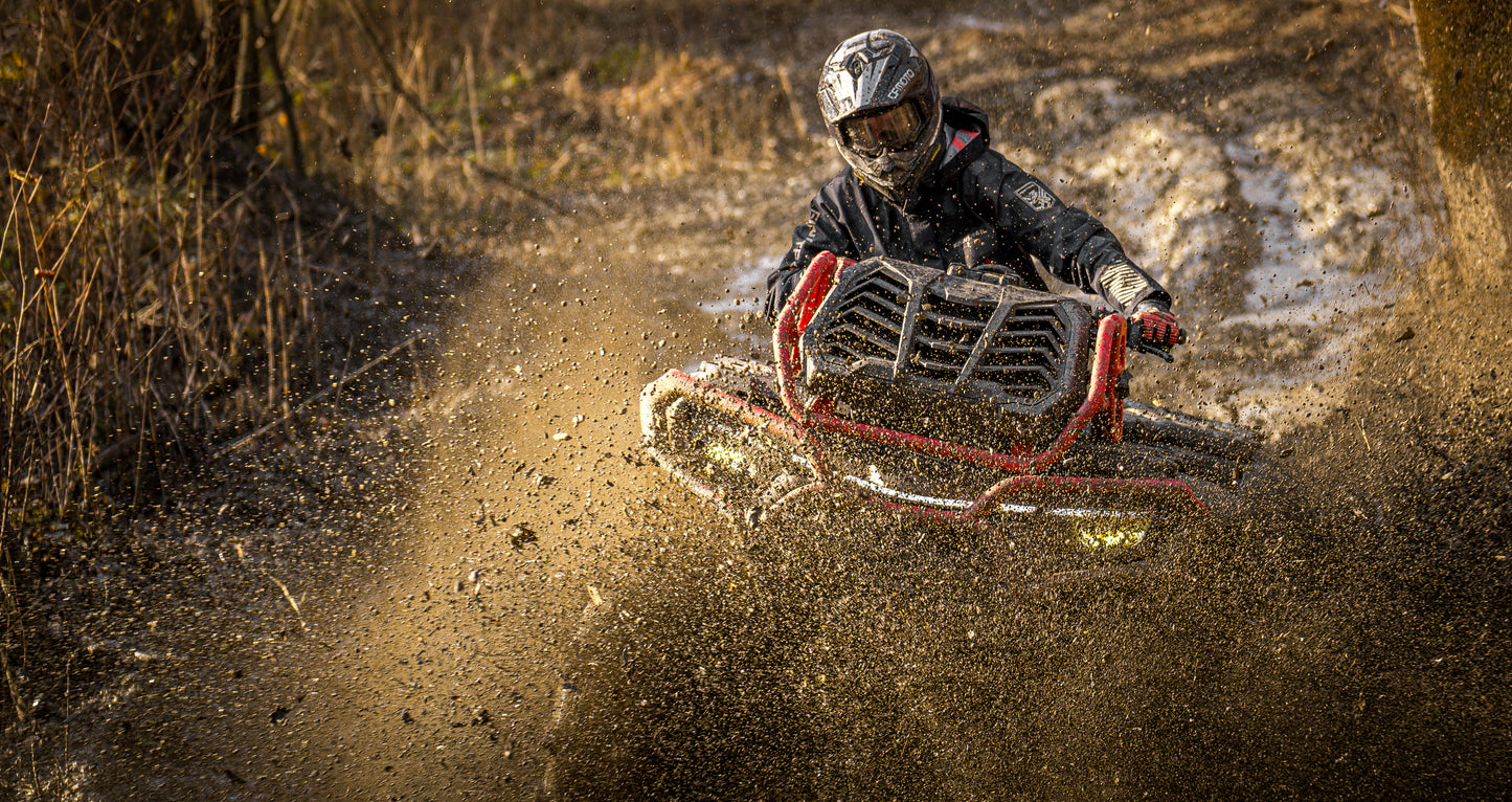 Person riding a CFMOTO 1000 MV ATV through a dusty landscape